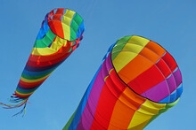 Close-up Of Two Large Colorful Wind Kite Tubes Flying In The Wind