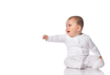 little baby reaching hand aside sitting on floor