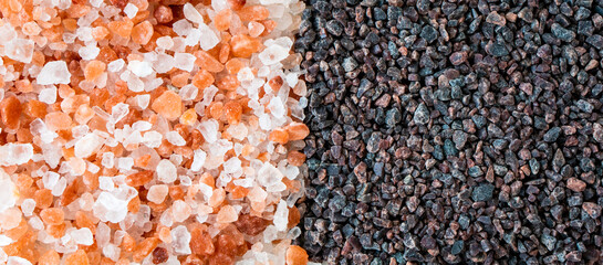 Close up black pink Himalayan salt with white natural mountain organic sea crystal rock powder flake bio healthy cook ingredient in grinder bottle glass on vintage rustic white kitchen wooden table