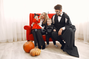 Wall Mural - Mother father and children in costumes and makeup. Family prepare to celebration of Halloween.