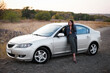 © inpoint_studio - a brunette girl in a leather jacket and black trousers near the car