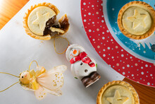 Preparing Christmas Decorations With Mince Pies On A Red Plate
