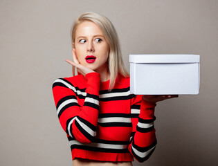 Sticker - Style surprised girl with white gift box on grey background