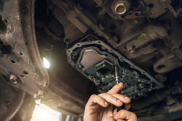 Wall Mural - CVT gearbox close up, worker hands changing oil and making maintenance in new modern variator automatic transmission on SUV in Car Service.