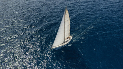 Wall Mural - Aerial drone photo of sailboat cruising in Mediterranean deep blue open ocean sea