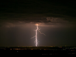 Wall Mural - eerie scenery of lightning strike hitting a town in a dark night