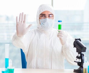 Young chemist student working in lab on chemicals