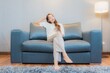 © siraphol - Portrait beautiful young asian woman relax on sofa in living room