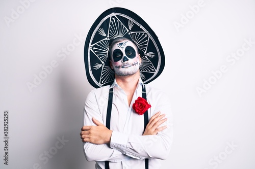 Fotomural Man wearing day of the dead costume over white skeptic and nervous, disapproving expression on face with crossed arms