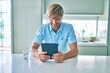 © Krakenimages.com - Young irish man smiling happy using touchpad sitting on the table at home.