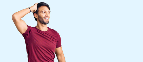 Handsome hispanic man wearing casual clothes smiling confident touching hair with hand up gesture, posing attractive and fashionable