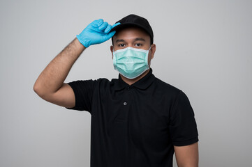 Wall Mural - Black uniform delivery asian man wearing protection mask and medical rubber gloves standing on isolated white background safety deliver concept.