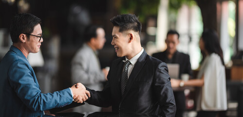 Wall Mural - Group of sucessful business person and coworker hand shaking with smile and happy for new start up project at the office conference meeting room