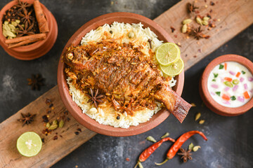 Poster - Fish biryani. Spicy Indian Malabar biryani or Hydrabadi biryani, Dum Biriyani,  fish and rice. pulao basmati rice, spicy mixed rice dish with meat curry for Ramadan Kareem, Eid