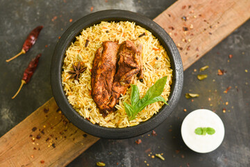 Wall Mural - Arabic chicken Manthi or mandi  cooked meat, Basmati rice with Masala, spice. Kuzhimanthi or hot and spicy Manthi on black background in Malabar Kerala,  South India. Top view of  Indian non veg food.