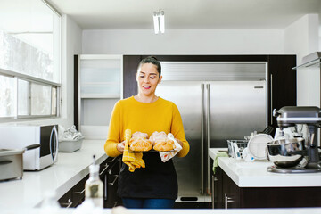 Poster - Mexican woman baking Pan de Muerto traditional bread from Mexico in Halloween