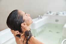 Charming Young Woman Washing Hair While Taking Bath