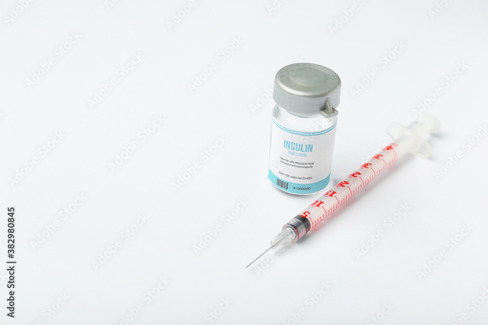 Bottle of insulin with syringe on white background. Diabetes concept