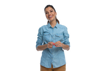 Wall Mural - cheerful smart casual woman laughing and playing with hands