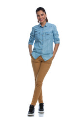 Wall Mural - positive smart casual woman holding hands in pockets and smiling