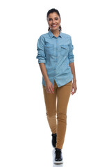 Wall Mural - happy smart casual woman smiling and walking