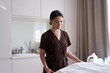 © Yakobchuk Olena - Smiling female masseur standing in massage parlor