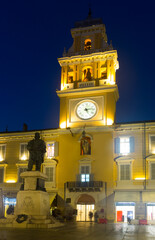 Wall Mural - Parma city hall illuminated at dusk and monument with clock bell in Italy