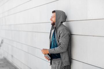 Wall Mural - fitness, sport and people concept - happy smiling young man with bottle of water outdoors