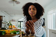 © Prins Productions - Beautiful focussed female researching recipe on smartphone standing next to chopped vegetables in organised kitchen.