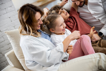 Wall Mural - Mother tickling, playing, joking with kids