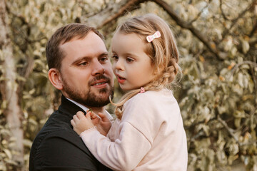 Young man holding little girl