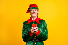 Portrait Of His He Nice Attractive Worried Confused Funny Guy Elf Using Gadget App 5g Blogging Browsing Post Comment Feedback Isolated Over Bright Vivid Shine Vibrant Yellow Color Background