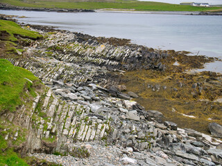 Wall Mural - Eroded strata in sea cliffs on the west coast of Kettla Ness off the west coast of Mainland, Shetland. These rocks are of the Colla Firth Formation - semipelite and psammite - metamorphic bedrock