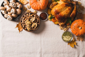 Wall Mural - Fall thanksgiving table with roasting chicken or turkey, nuts, pie, pumkins and other food on light