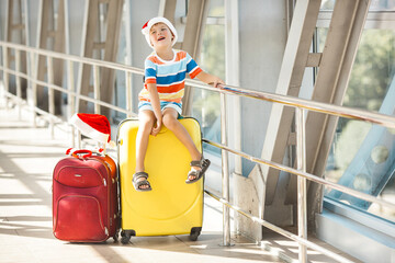 Wall Mural - Happy kid at the airport in christmas cap