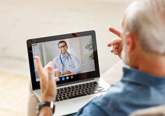 Senior man speaking with online doctor.