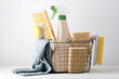 Eco brushes, sponges and rag in cleaning basket. Cleaner concept on white background