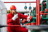 Fototapeta  - Technician in oil and gas refinery. Worker in Oil Refinery.