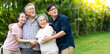 © NVB Stocker - Asian family with love. 4 People. happy family shows love by hugging each other on the lawn at home.