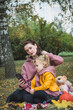 © bisonov - Mom and three year old daughter are playing in the autumn park