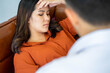 © ake - caucasian medical doctor psychologist  consulting the mental health patient female sitting in couch  in the clinic office. Health care and medical concept.