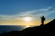 © oh_hyyo - Silhouette of a nature photographer framing a shot, taking pictures at sunset on the beach