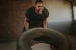 © Jacob Lund - Strong man doing heavy tire flip exercise