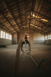 © Jacob Lund - Tough female working out with battling ropes