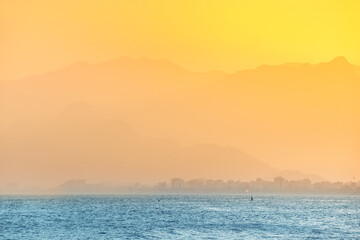 Wall Mural - Golden sunset at the mediterranean seacost in Antalya city. Vacation and tour on the Mediterranean coast of Turkey