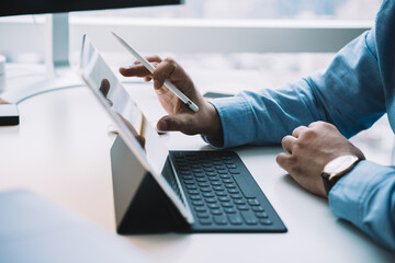 Male hands with stylus working on modern tablet