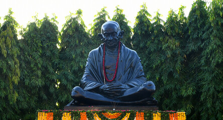 Black stone statue of the Father Of Nation Mahatma Gandhi, who employed nonviolent resistance to lead the successful campaign for India's independence from British rule. 
