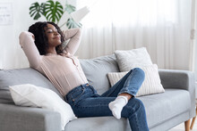 Weekend At Home. Relaxed African American Woman Leaning Back On Couch
