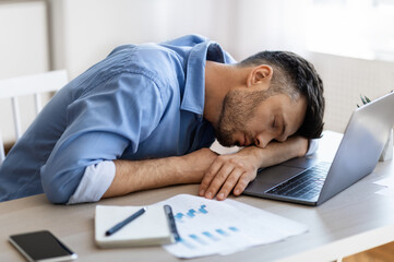 Wall Mural - Sleep At Work. Exhausted overworked man employee napping at workplace in office