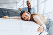 © fotofabrika - Young couple man and woman hugging their new car in a car shop